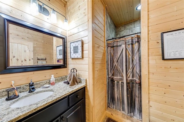 full bathroom featuring a shower with curtain, wooden walls, wood ceiling, and vanity