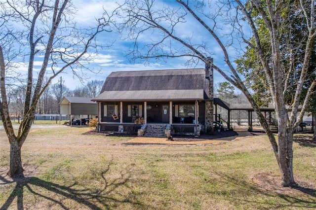 view of front of property with a carport, covered porch, a shingled roof, and a front yard