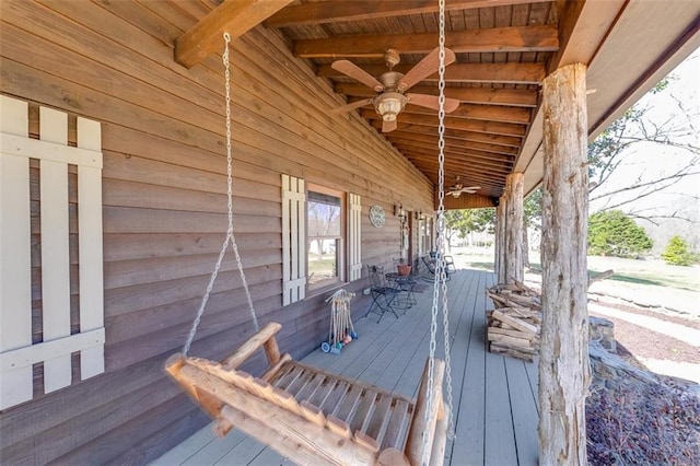 wooden terrace featuring a ceiling fan