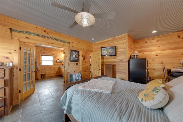 bedroom with recessed lighting, wood walls, and french doors