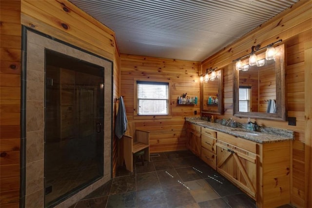 full bathroom with a sink, a stall shower, double vanity, and wood walls