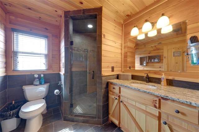 full bathroom featuring vanity, wooden walls, a shower stall, wooden ceiling, and toilet