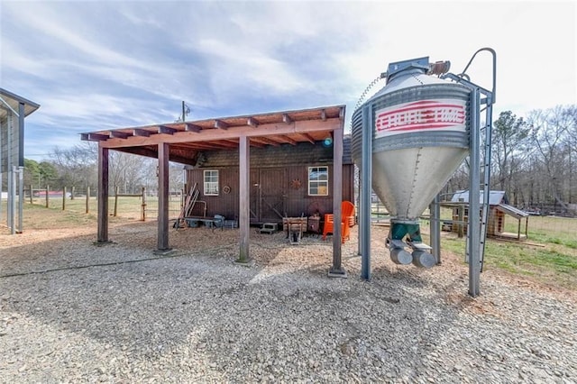 view of community with a detached carport and driveway