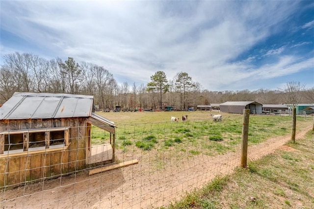 view of yard with a rural view and an outdoor structure