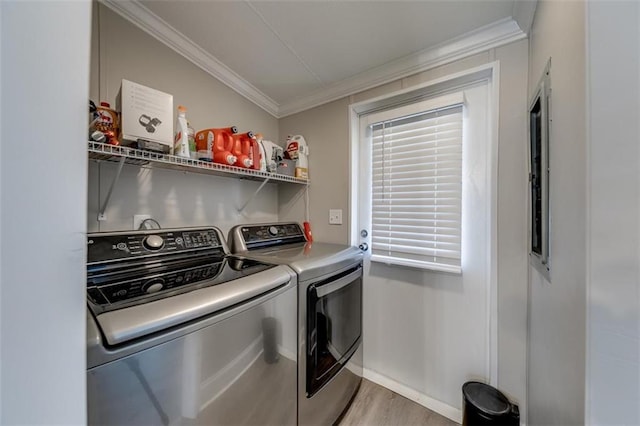 laundry area with baseboards, laundry area, light wood-style flooring, separate washer and dryer, and ornamental molding