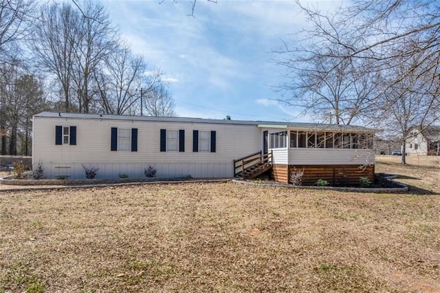 view of front of property with a front lawn and a sunroom