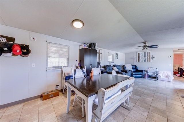 dining room featuring light tile patterned floors, lofted ceiling, and ceiling fan