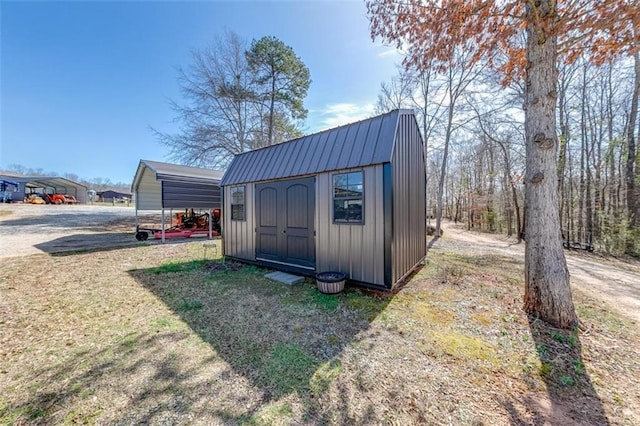 view of shed featuring a detached carport and dirt driveway