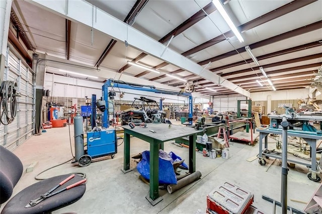 miscellaneous room featuring a workshop area and unfinished concrete floors