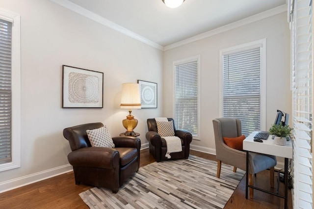 living area featuring crown molding and hardwood / wood-style flooring