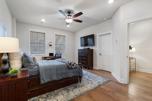 bedroom with ceiling fan and light hardwood / wood-style flooring