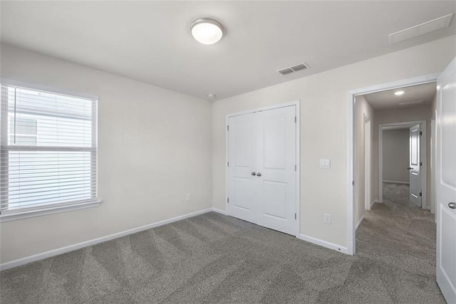 unfurnished bedroom featuring a closet and carpet