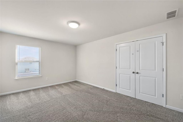 unfurnished bedroom with carpet floors and a closet