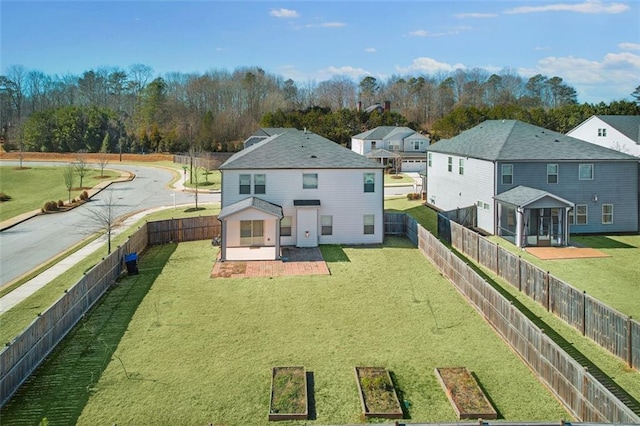 rear view of house with a yard, a sunroom, and a patio area