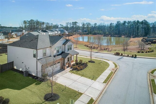 birds eye view of property with a water view