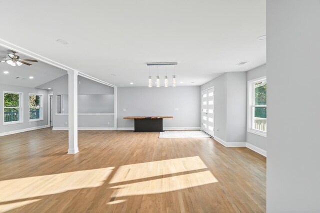 unfurnished living room with ceiling fan and light wood-type flooring