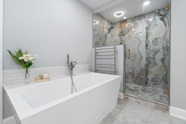 bathroom with separate shower and tub