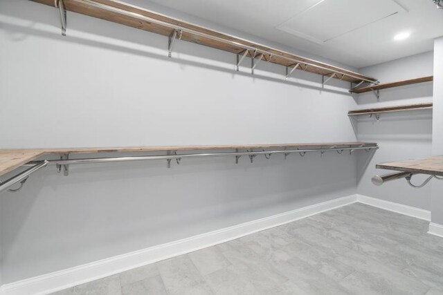 spacious closet featuring light wood-type flooring