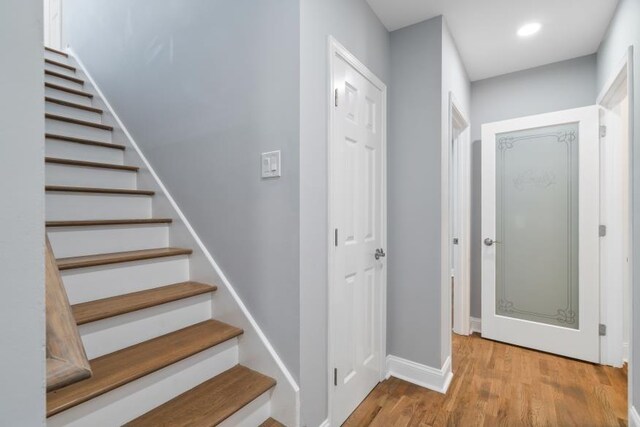 staircase with wood-type flooring