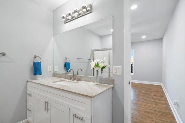 bathroom with hardwood / wood-style floors and vanity