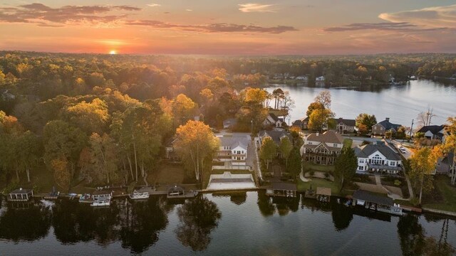 aerial view at dusk featuring a water view