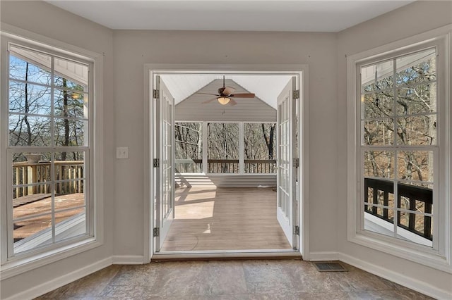 doorway with baseboards and visible vents