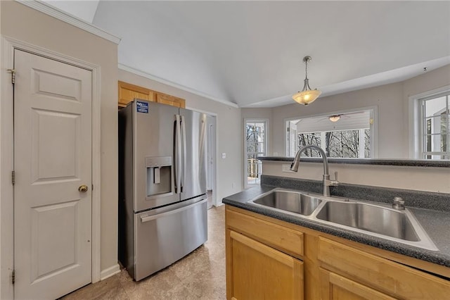 kitchen with dark countertops, vaulted ceiling, a sink, and stainless steel fridge with ice dispenser