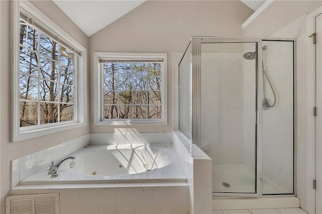 bathroom featuring a stall shower, lofted ceiling, visible vents, and a tub with jets