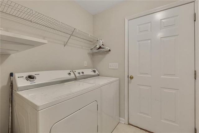 clothes washing area with washer and dryer and laundry area