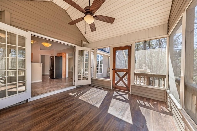 unfurnished sunroom featuring plenty of natural light, wooden ceiling, vaulted ceiling, and ceiling fan