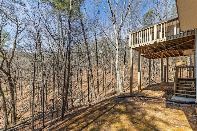 view of yard featuring stairway and a deck