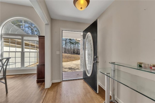 entrance foyer with light wood-style flooring and baseboards