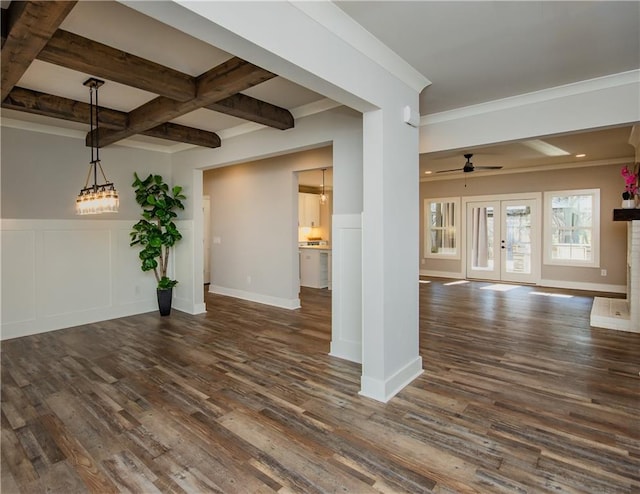 spare room featuring a decorative wall, dark wood-type flooring, coffered ceiling, french doors, and beamed ceiling