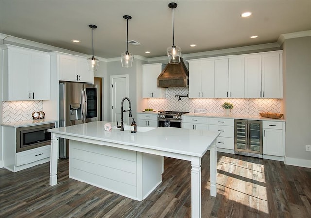 kitchen featuring visible vents, wine cooler, appliances with stainless steel finishes, crown molding, and premium range hood