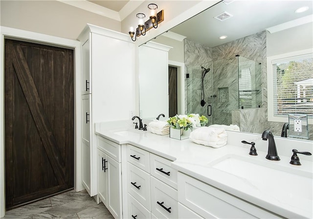 bathroom with marble finish floor, double vanity, a sink, and a marble finish shower