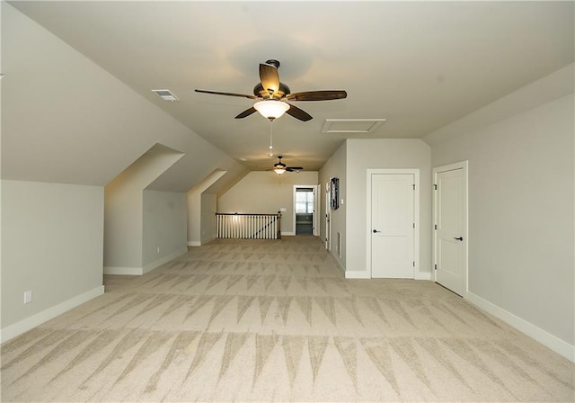 bonus room featuring attic access, lofted ceiling, light carpet, and baseboards