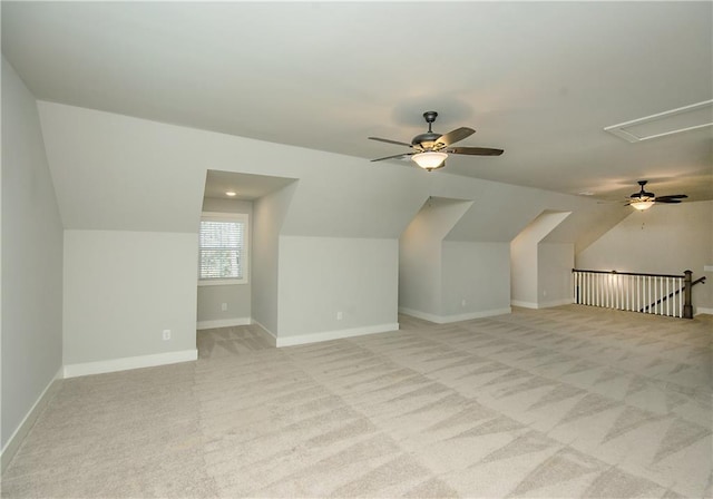 bonus room with light carpet, attic access, baseboards, and lofted ceiling