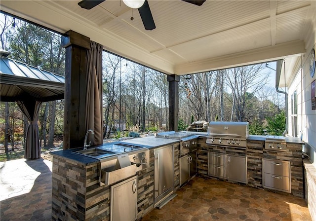 view of patio / terrace with area for grilling, a grill, and a ceiling fan