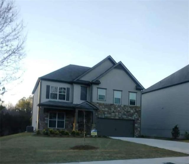 view of front of house with a garage and a front lawn