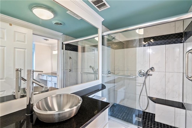 bathroom with visible vents, vanity, a stall shower, and crown molding