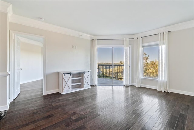 empty room featuring crown molding, baseboards, and dark wood-style flooring