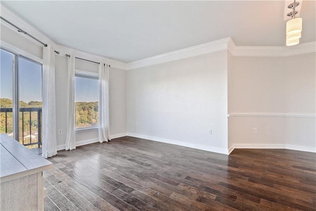 unfurnished room with ornamental molding, baseboards, and wood finished floors