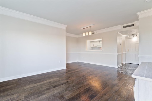 unfurnished living room featuring dark wood finished floors, visible vents, crown molding, and baseboards