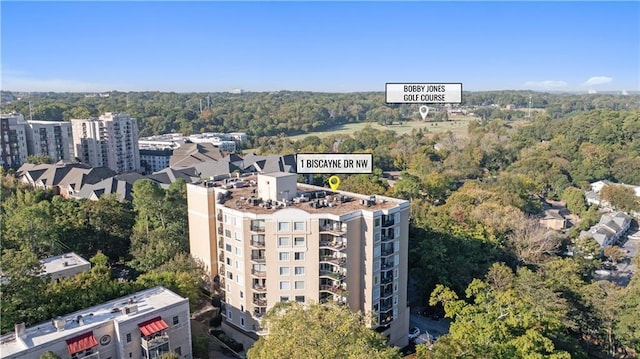 drone / aerial view featuring a wooded view