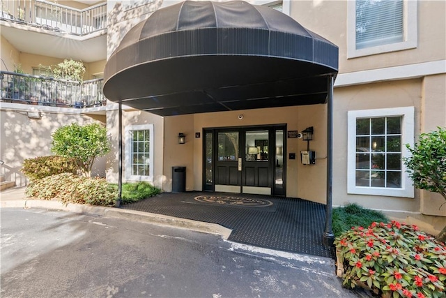 entrance to property featuring stucco siding