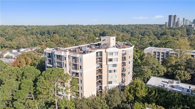 drone / aerial view featuring a wooded view