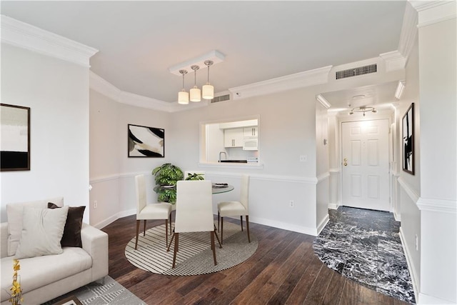 dining space with visible vents, baseboards, dark wood-style flooring, and crown molding