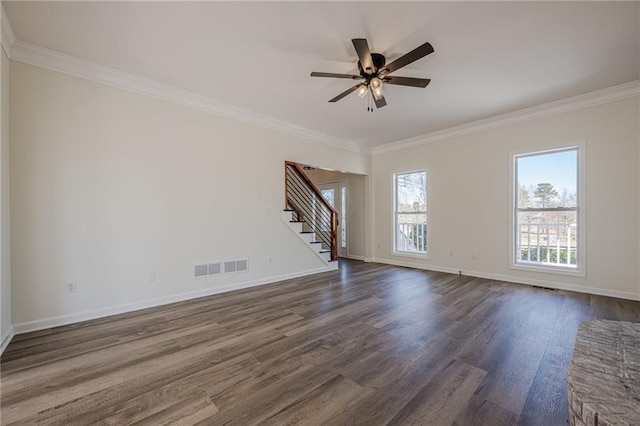empty room featuring stairway, dark wood finished floors, visible vents, and baseboards