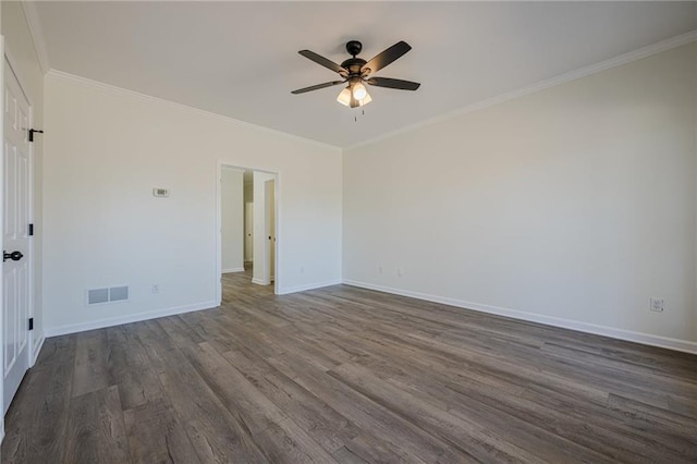 unfurnished room featuring baseboards, visible vents, dark wood-type flooring, and ornamental molding