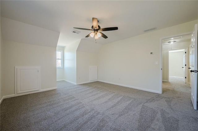 bonus room featuring lofted ceiling, carpet, visible vents, and baseboards